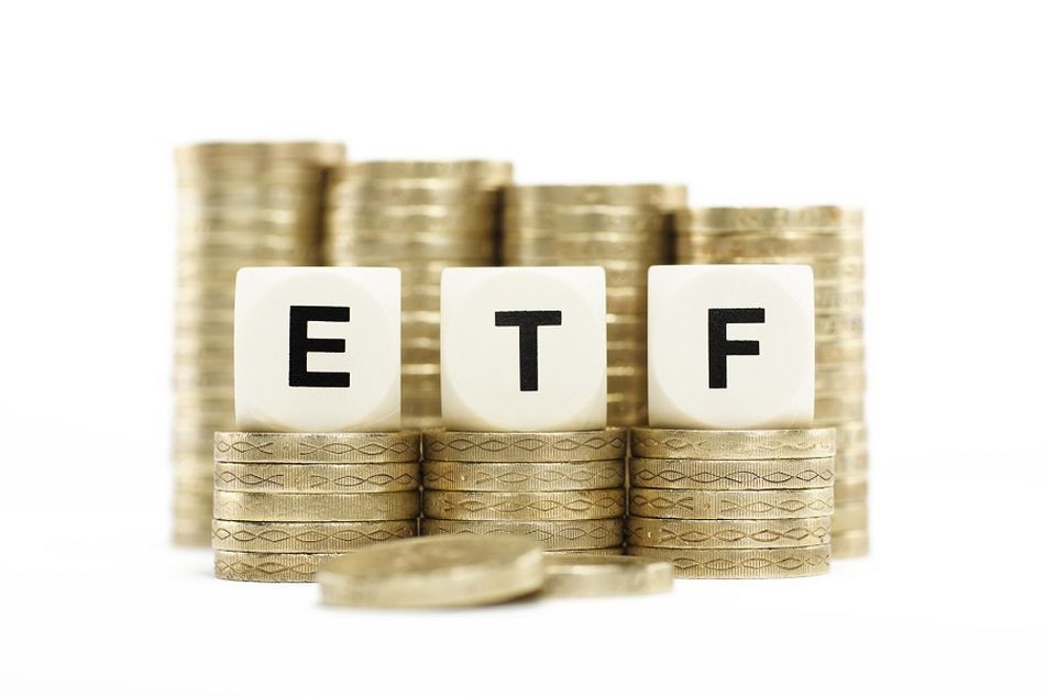 coins behind dice with ETF
