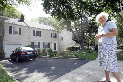 An unnamed woman talks to reporters after taking photos of 31 Marquette Road, left, in Montclair, N.J., Tuesday, June 29, 2010.