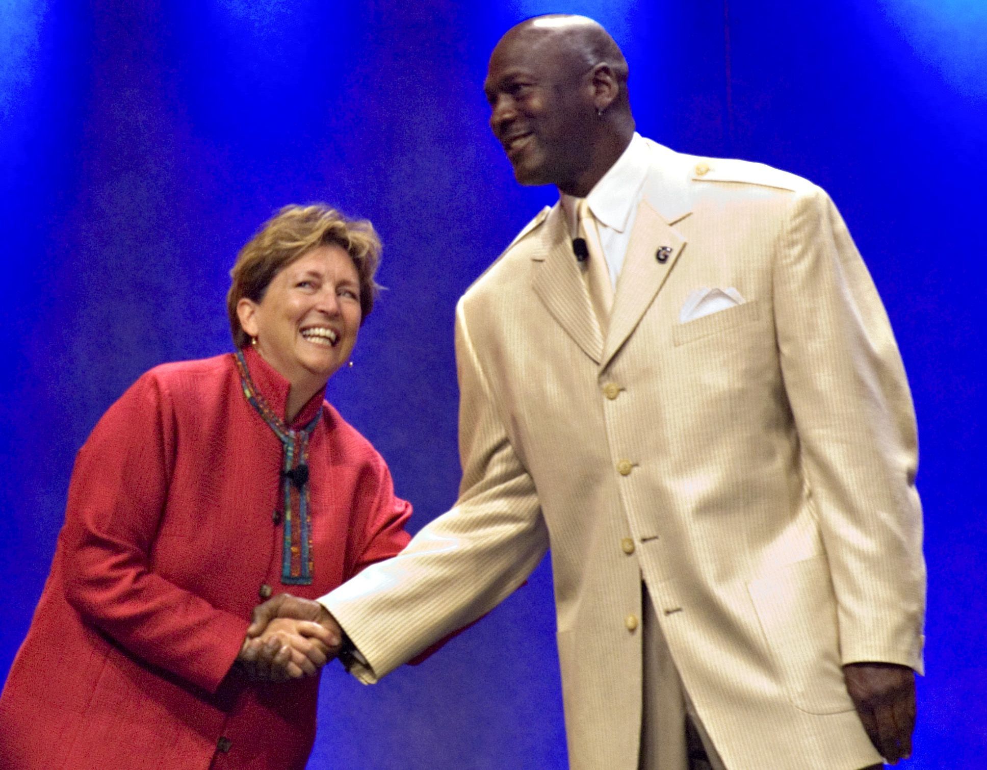 Rob Walton, executive vice president of Wal-Mart Stores Inc.'s People Division, left, greets former basketball player Michael Jordan during the annual Wal-Mart shareholders meeting in Fayetteville, Arkansas, U.S.