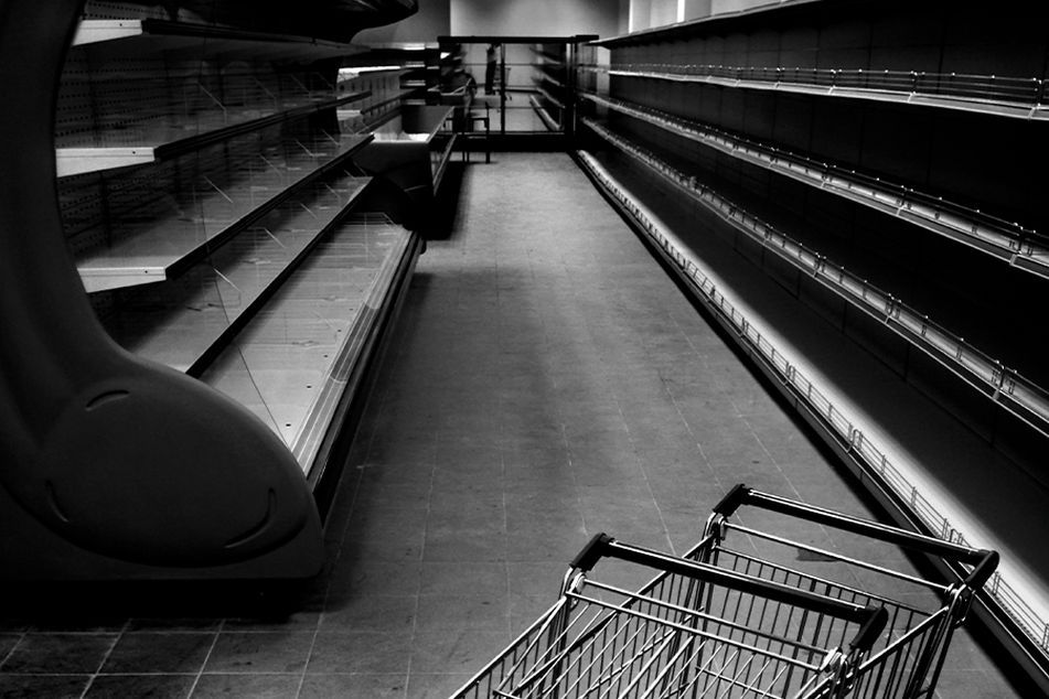 b&w store aisle empty shelves