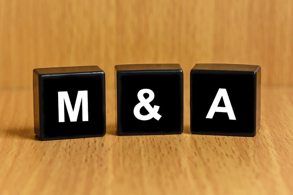M and A mergers and acquisitions text on blocks