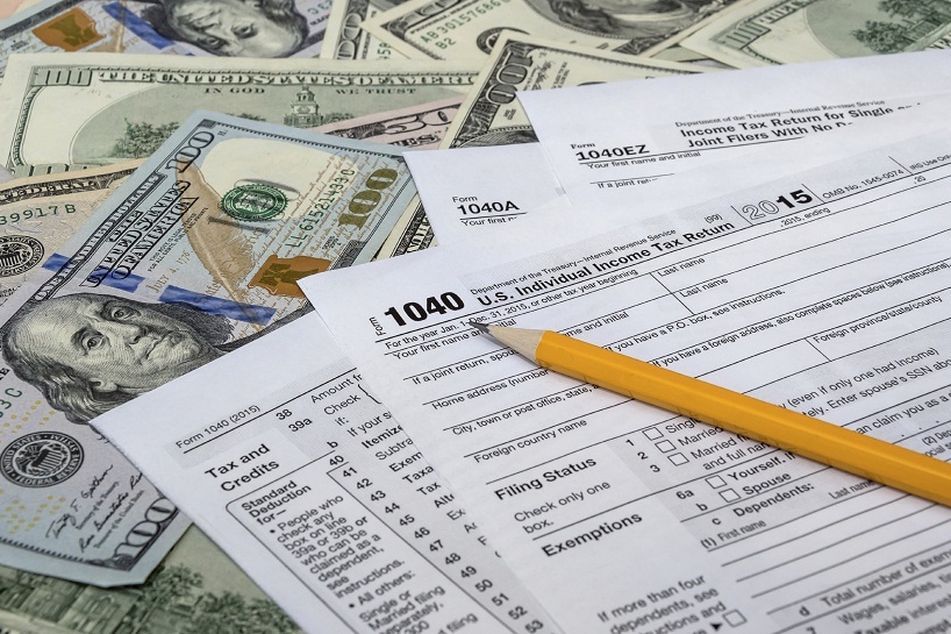 tax forms and dollar bills