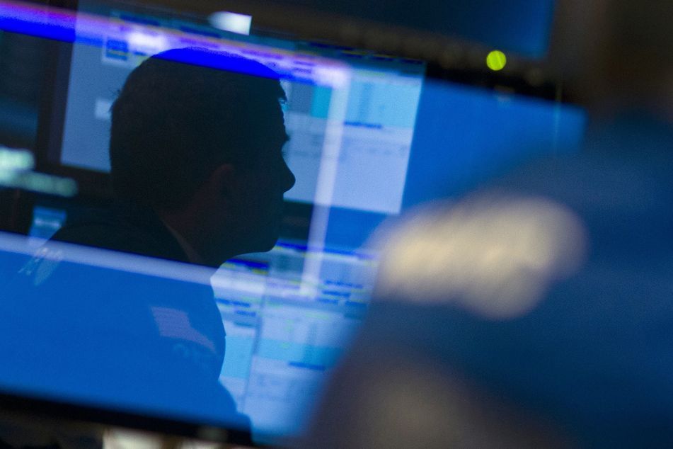 nyse trader reflected in monitor