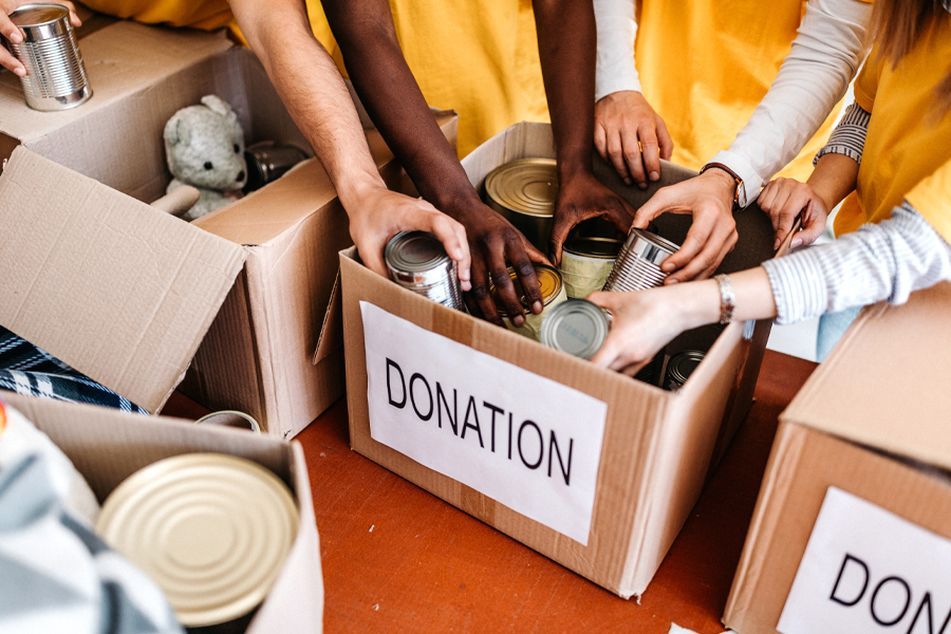 people donating food in box