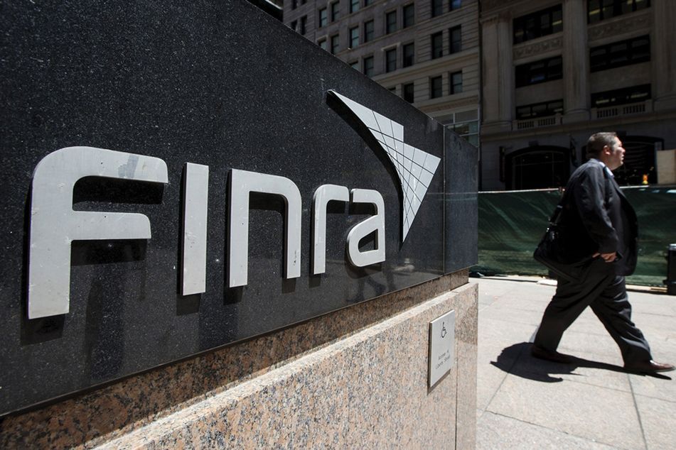 Man walking by Finra sign