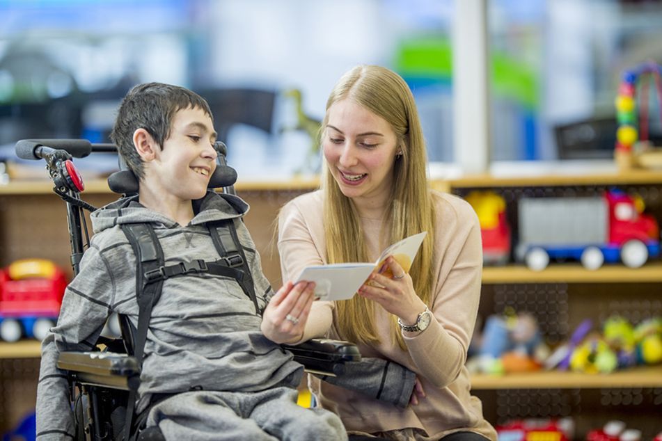 woman-reading-story-to-boy-in-wheelchair