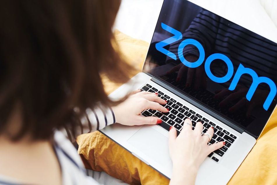 woman calling up Zoom on laptop