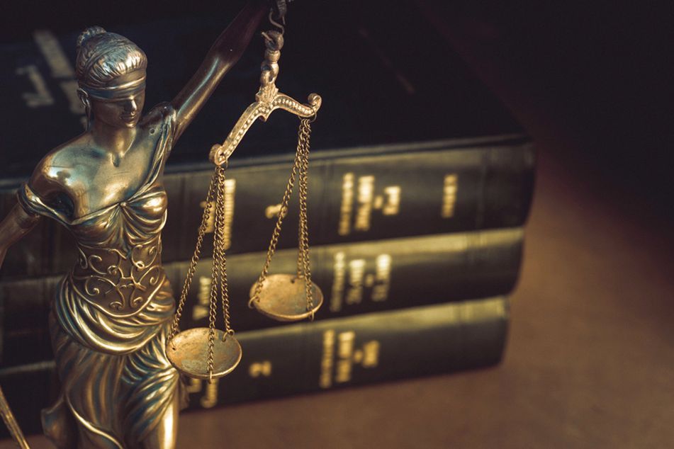 law-books-and-statue-of-justice-with-scales