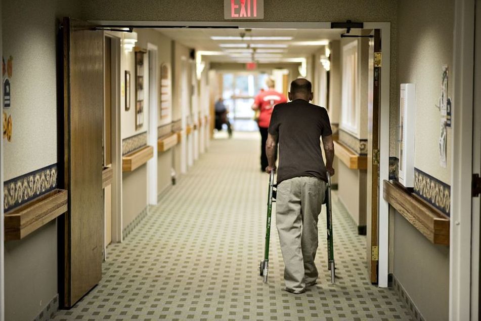 man-using-walker-in-nursing-home