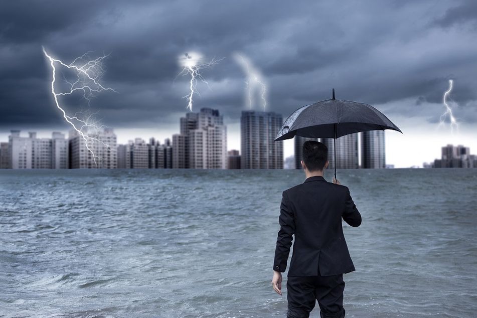Adviser-under-umbrella-looks-at-lightning-in-the-distance