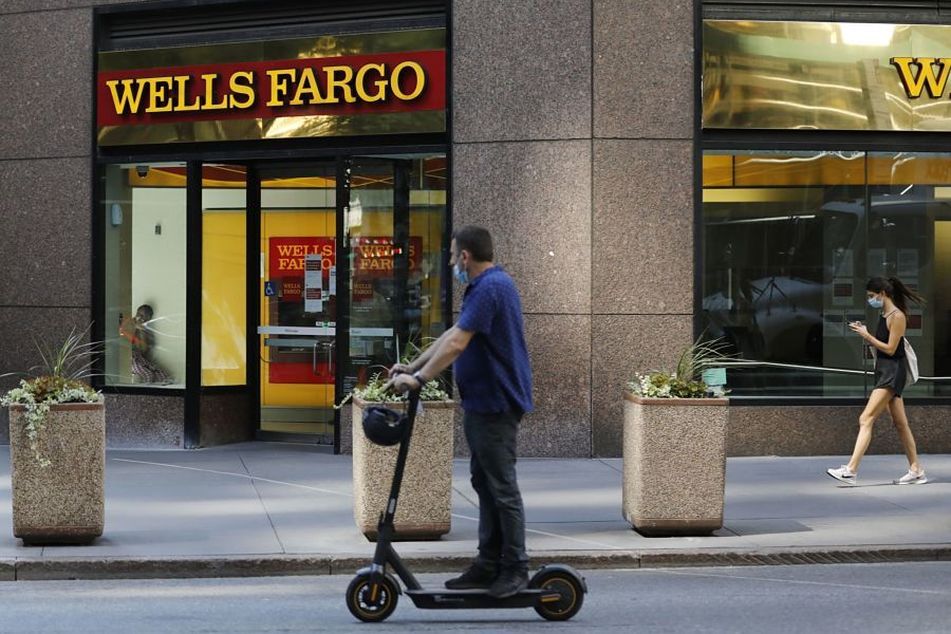 man-with-mask-on-scooter-in-front-of-wells-fargo-branch