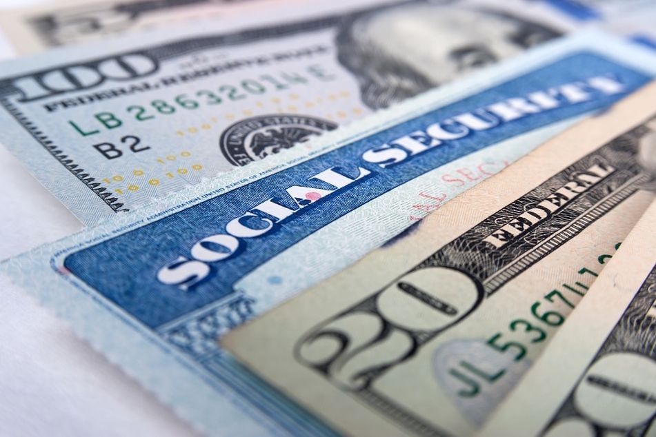 Social-Security-card-amid-twenty-dollar-bills