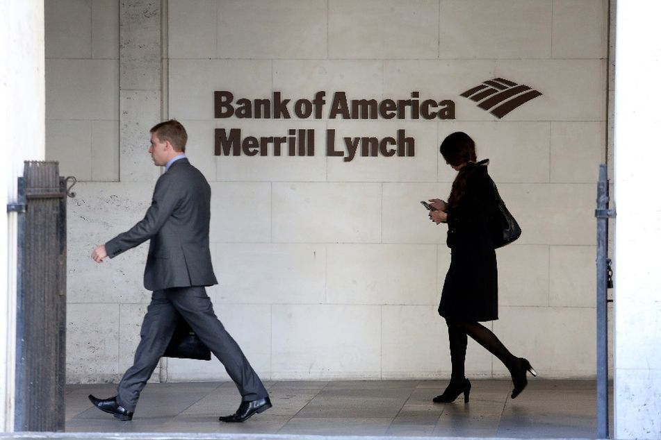 man-and-woman-walking-past-Merrill-Lynch-logo