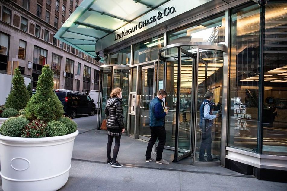 people-with-masks-entering-revolving-door-at-JPMorgan-building