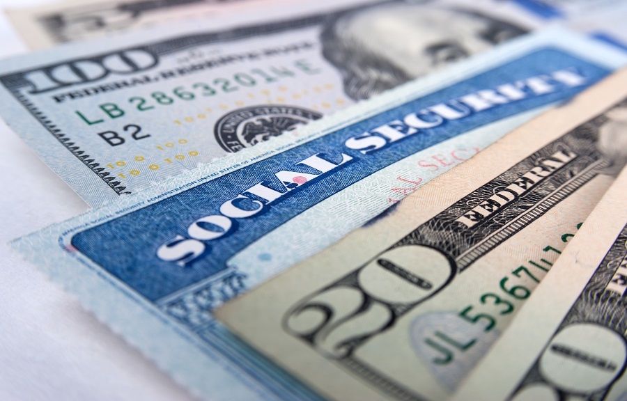 Social security card and American money dollar bills close up concept