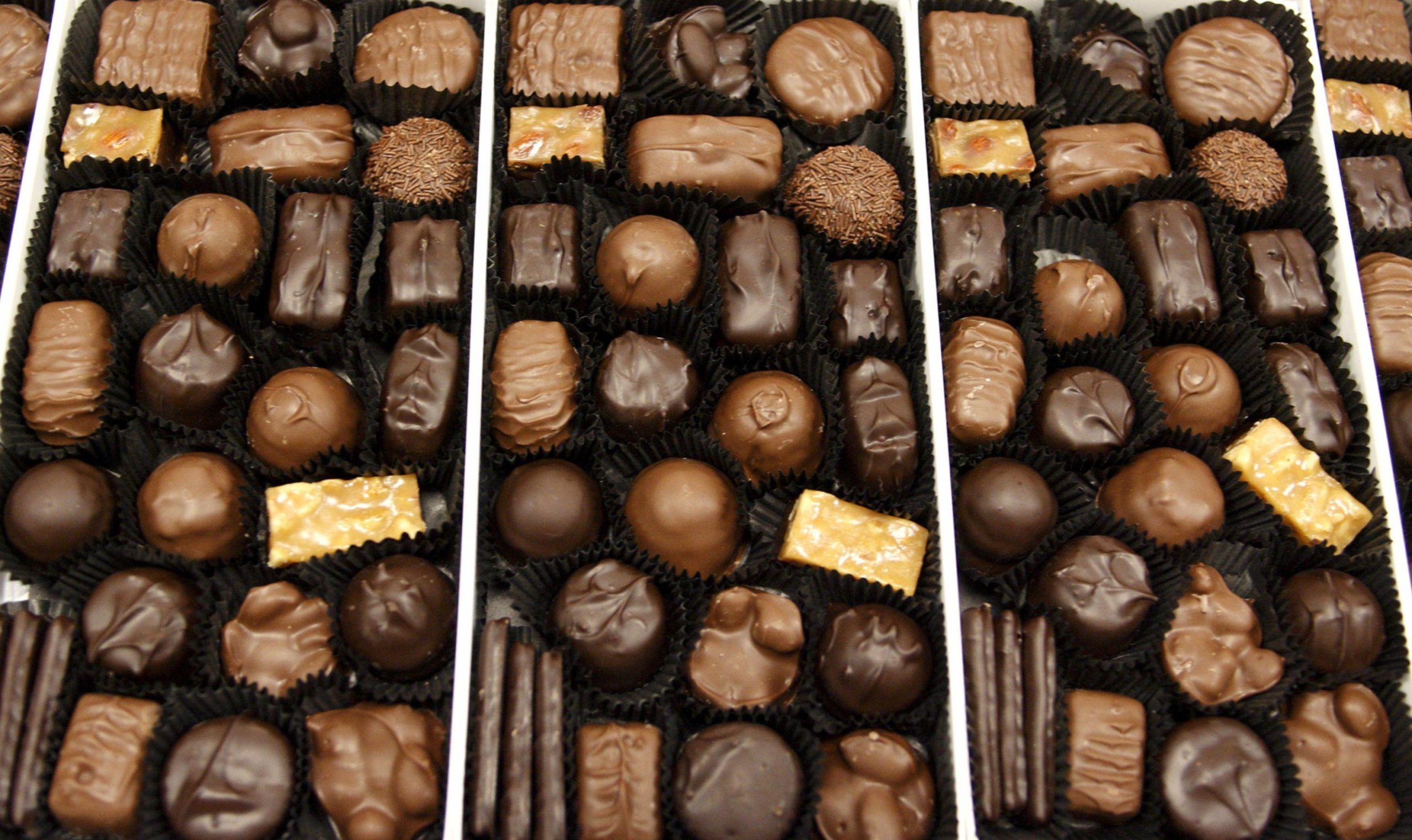 A box of assorted chocolates moves along the production line at the See's Candies Inc. packing facility in South San Francisco, California, U.S.,