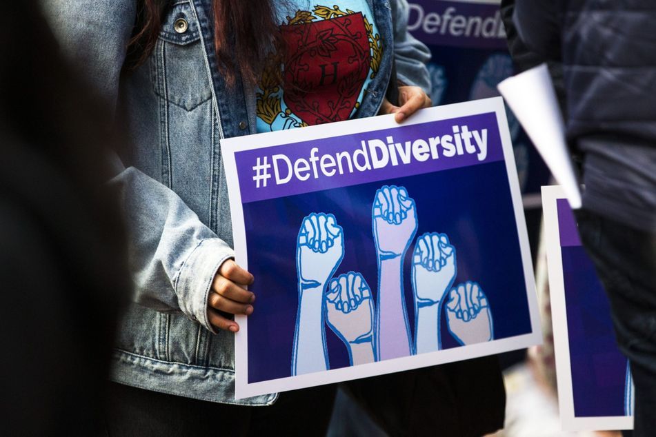 defend diversity protest sign black