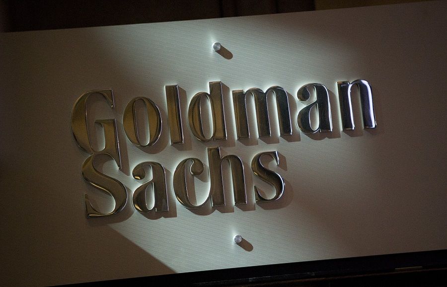 The Goldman Sachs & Co. logo is displayed at the company's booth on the floor of the New York Stock Exchange (NYSE) in New York, U.S., on Friday, July 19, 2013. U.S. stocks fell after benchmark equities gauges rose to records yesterday, after disappointing earnings from Google Inc. and Microsoft Corp. overshadowed better-than-forecast results from General Electric Co. Photographer: Scott Eells/Bloomberg