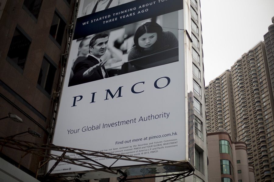 A Pacific Investment Management Company LLC (PIMCO) advertisement is displayed on a building in Hong Kong, China, on Wednesday, Nov. 13, 2013. Pacific Investment Management Co.s Bill Gross raised the percentage of Treasuries and other U.S. government-related debt in his flagship fund in October after the Federal Reserve unexpectedly maintained its bond purchases. Photographer: Brent Lewin/Bloomberg