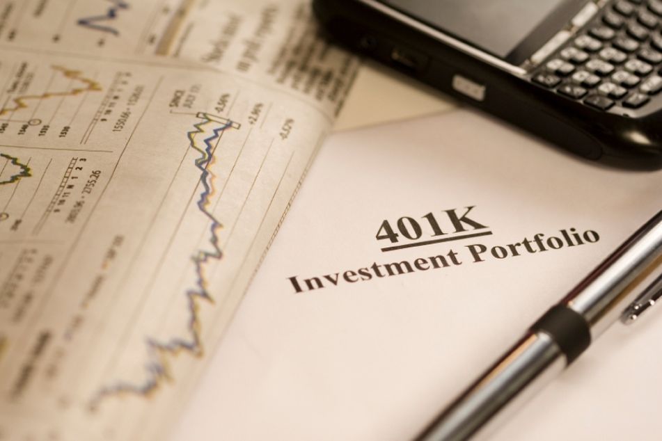 document labeled 401K Investment Portfolio, along with pen and adding machine
