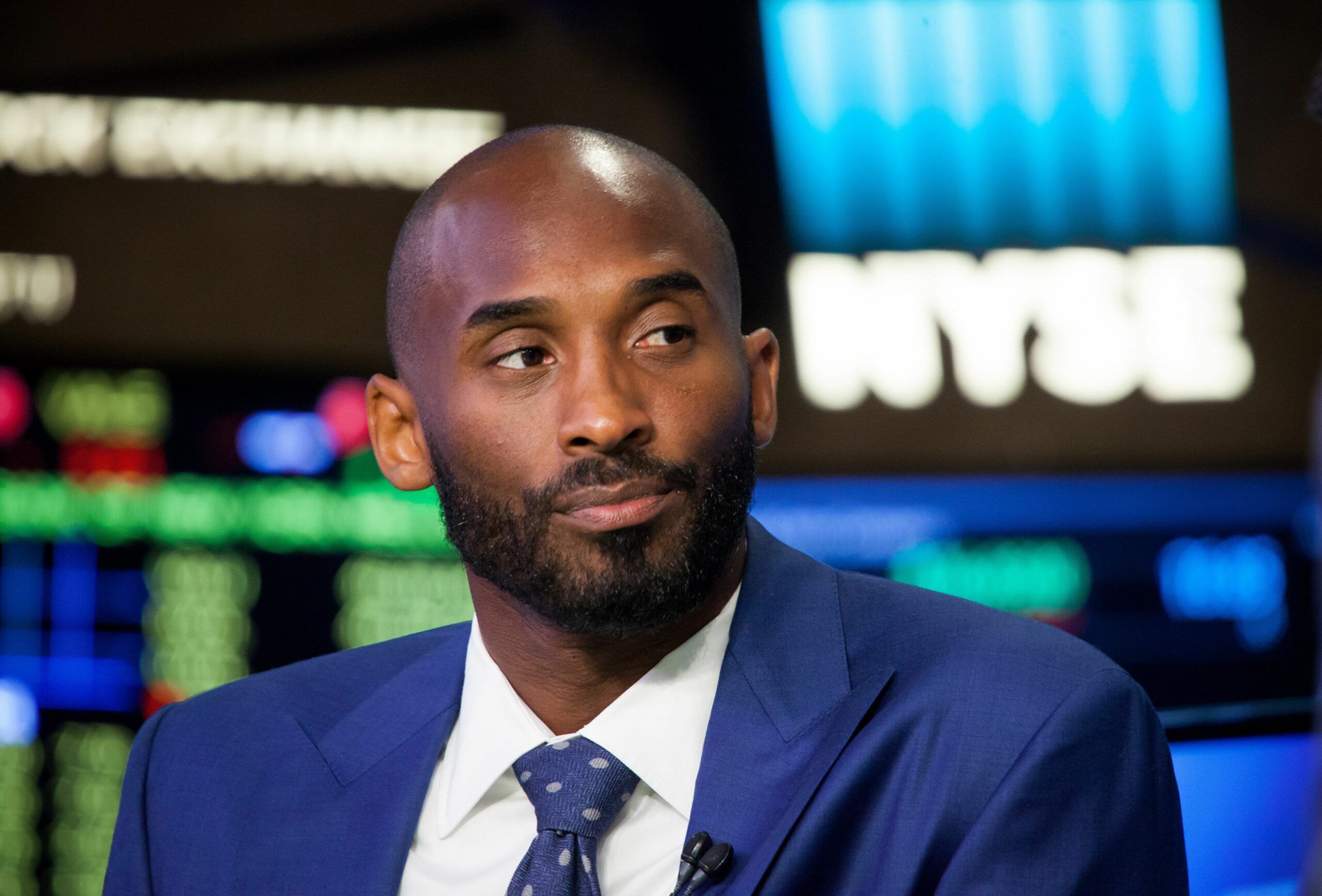 Kobe Bryant, former National Basketball Association (NBA) player, listens during an interview after unveiling his venture-capital fund Bryant Stibel on the floor of the New York Stock Exchange (NYSE) in New York, U.S., on Monday, Aug. 22, 2016. U.S. stocks fluctuated after erasing an early slide, as a rally in drugmakers spurred by deal activity offset declines in commodity shares led by falling crude-oil prices. Photographer: Michael Nagle/Bloomberg