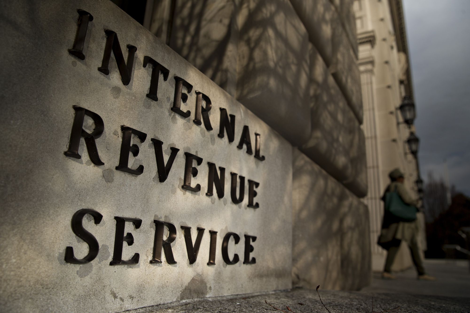 A woman walks out of the Internal Revenue Service (IRS) headquarters building in Washington, D.C. Photographer:Andrew Harrer/Bloomberg