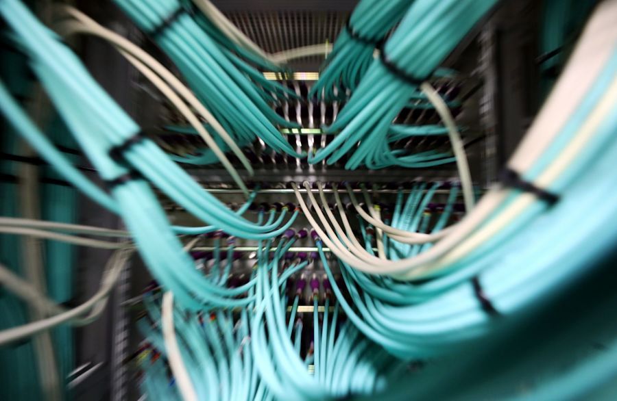 Coaxial cables connect to a computer server unit inside a communications room at an office in London, U.K., on Monday, May 15, 2017. Governments and companies around the world began to gain the upper hand against the first wave of an unrivaled global cyberattack, even as the assault was poised to continue claiming victims this week. Photographer: Chris Ratcliffe/Bloomberg