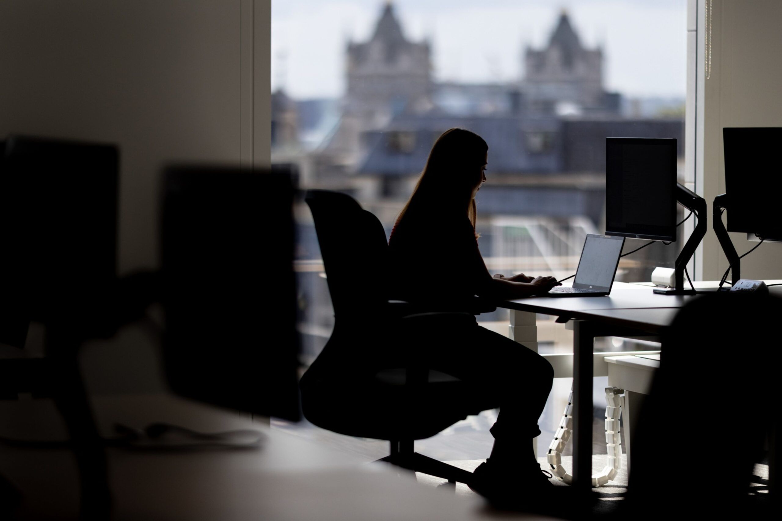 An office worker at a desk in London. Photographer: Jason Alden/Bloomberg