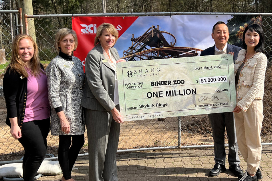 Lead donors Charles Zhang and Lynn Chen-Zhang hand over a cheque after a fundraising campaign to raise money for Binder Park Zoo in Battle Creek, Michigan.
